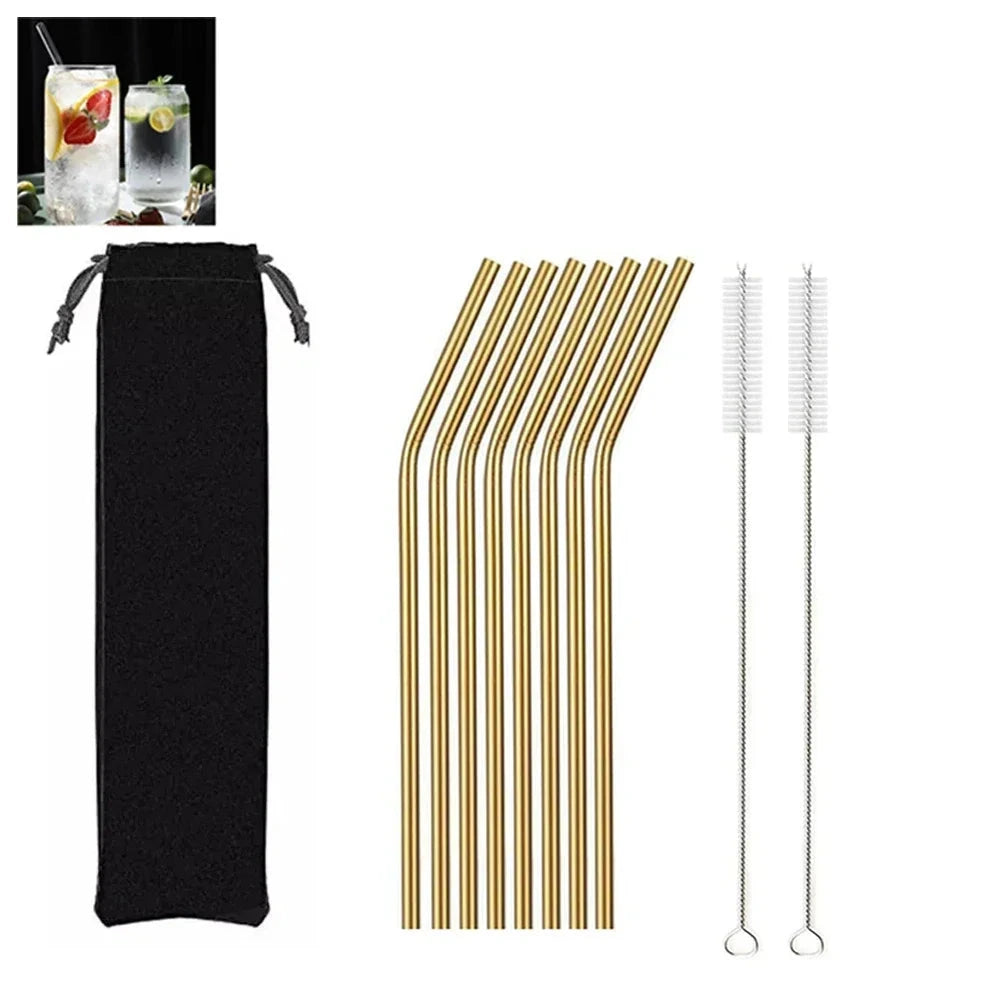Set of gold metal straws with cleaning brush and black pouch on a white background